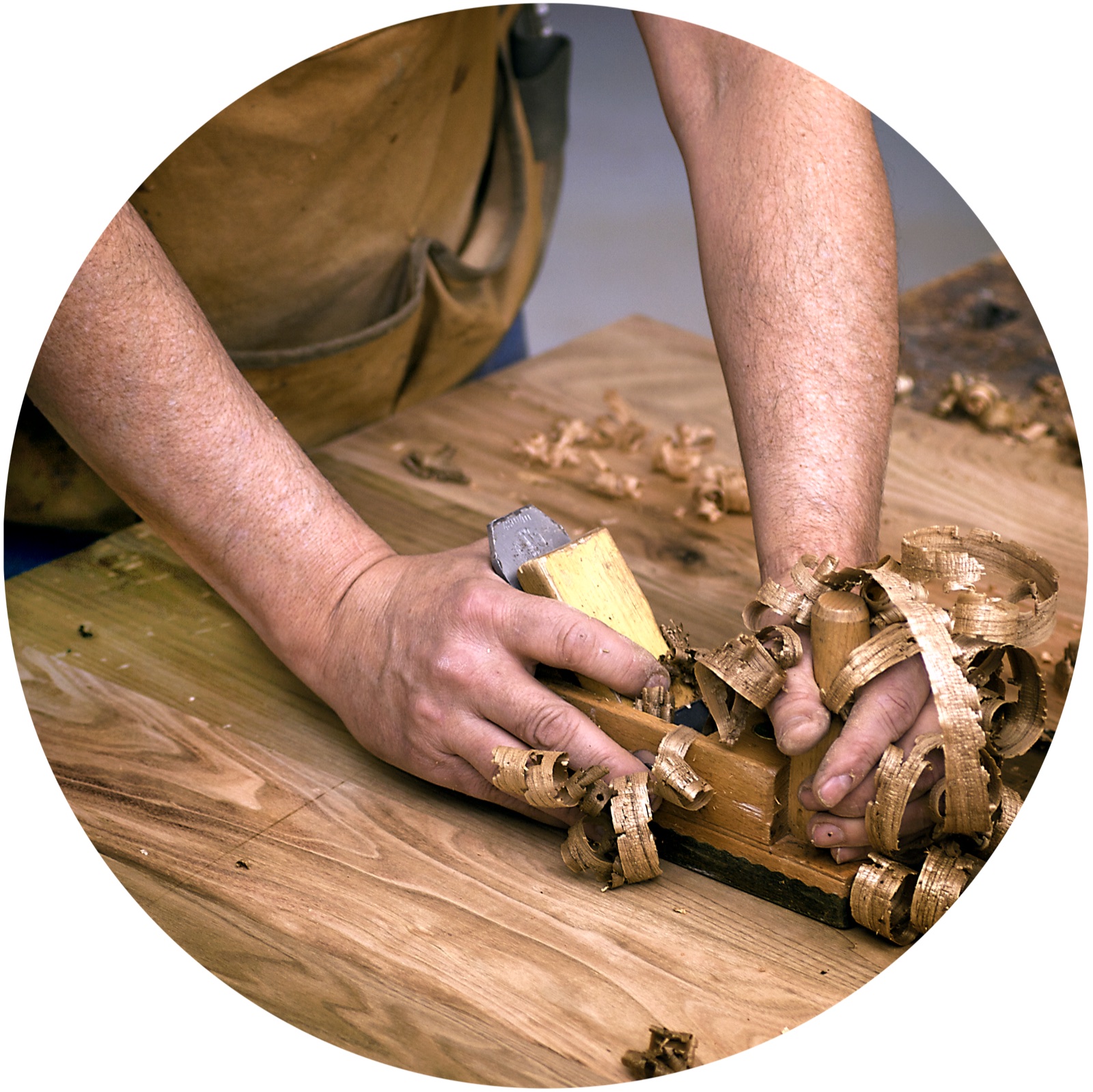 A craftsman hand-planing a door